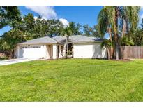 Charming one-story home with a well-manicured lawn and mature trees, enhancing its curb appeal at 4805 Cypress Lake Ct, Sarasota, FL 34243