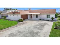 Well-maintained home with a large driveway and manicured landscaping at 6341 Cocoa Ln, Apollo Beach, FL 33572
