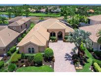 Expansive single-story home featuring a tile roof, brick driveway, and mature landscaping at 7037 Brier Creek Ct, Lakewood Ranch, FL 34202