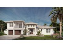 Elegant two-story home with a manicured lawn, two-car garage, and lush tropical landscaping at 8006 20Th W Pl, Bradenton, FL 34209