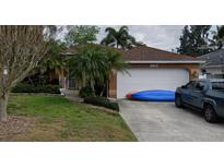 Charming single-story home with a two-car garage, mature landscaping, and well-manicured lawn at 853 Albritton Ave, Sarasota, FL 34232