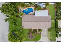 Aerial view of a home with a backyard swimming pool and lush tropical landscaping at 1004 68Th Nw St, Bradenton, FL 34209