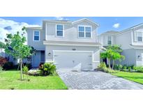 Charming two-story home with a paved driveway and a well-manicured front yard at 14312 Crimson Ave, Bradenton, FL 34211