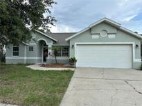 Charming single-story home with a well-manicured lawn and attached two-car garage at 185 Wood Dove Ave, Tarpon Springs, FL 34689