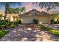 Charming single-story home with a well-manicured front yard and a two-car garage at 2411 New Haven Cir # 70, Sun City Center, FL 33573