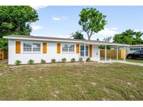 Charming single-story home with tidy landscaping, white exterior, and wood-style shutters at 2802 21St W St, Bradenton, FL 34205