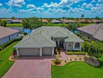 Beautiful home featuring manicured landscaping, a three-car garage, and located on a pristine waterfront property at 2875 Grazeland Dr, Sarasota, FL 34240