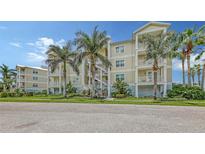 Beautiful multi-story condo complex featuring tropical landscaping and exterior staircases at 3430 77Th W St # 301, Bradenton, FL 34209
