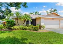 Charming single-story home featuring a well-manicured lawn and tropical landscaping with lovely curb appeal at 3530 Wilkinson Woods Dr # 14, Sarasota, FL 34231