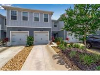 Charming two-story townhome with attached garage, beautiful landscaping, and inviting curb appeal at 4728 Old Blush St, Bradenton, FL 34211