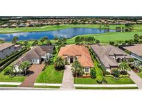 Stunning lakefront home with lush landscaping, tile roof and golf course views in a desirable community at 5104 Benito Ct, Bradenton, FL 34211