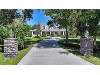Stunning estate with long driveway, lush lawn, mature trees, and timeless curb appeal at 6050 Saddle Oak Trl, Sarasota, FL 34241