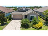Charming single-story home features a manicured lawn and a welcoming two-car garage at 11223 Spring Gate Trl, Bradenton, FL 34211