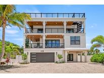 Stunning three-story beach house with a spiral staircase and multiple balconies at 119 Avenida Messina, Sarasota, FL 34242