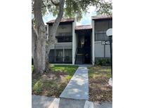 Charming condo with tiled roof, screened porch, and a well-maintained front yard at 3245 Beneva Rd # 203, Sarasota, FL 34232
