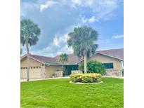 Charming single-story home featuring lush landscaping and a well-manicured front lawn at 3764 Torrey Pines Blvd, Sarasota, FL 34238