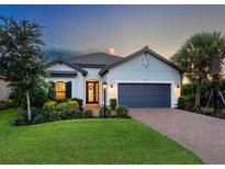 Charming one-story home featuring a 2-car garage, landscaped yard, and welcoming entrance, perfect for comfortable living at 4704 Sarca Ct, Lakewood Ranch, FL 34211