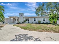 Charming single-story home with a well-manicured lawn and a spacious driveway, perfect for suburban living at 4819 Palmetto Point Dr, Palmetto, FL 34221