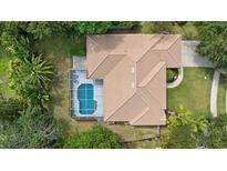 Overhead view of home featuring a screened-in pool, and a neutral-colored roof at 5619 Oak Grove Ct, Sarasota, FL 34233
