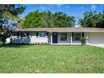 Charming single-story home featuring a well-manicured lawn, tidy landscaping and attached two-car garage at 616 59Th Nw St, Bradenton, FL 34209
