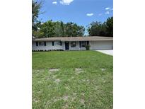 Charming single story home featuring a well-manicured lawn, attached two car garage and shuttered windows at 616 59Th Nw St, Bradenton, FL 34209