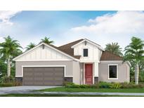 Charming single-Gathering home boasting a two-car garage, red door, and landscaped front yard for curb appeal at 6555 Big Bayou Dr, Sarasota, FL 34241