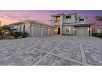 Stunning home boasts a spacious driveway, three-car garage, and manicured landscaping at 676 Regatta Way, Bradenton, FL 34208