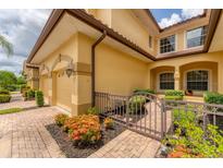 Charming home exterior showcasing a well-maintained yard and inviting entryway with lovely landscaping at 8261 Miramar Way # 8261, Lakewood Ranch, FL 34202