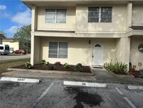Charming townhouse featuring tidy landscaping and reserved guest parking at 201 Elliot Ave, Sarasota, FL 34232