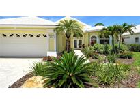 Charming, yellow single-Gathering home with a well-manicured front yard and bright white trim at 340 Bermuda Ct # 5, Venice, FL 34293