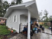 View of the side of the home, showing the siding, windows and fenced-in backyard at 400 Tweed Ave, Seffner, FL 33584