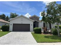 Charming single Gathering home with a stone accents and a two-car garage and a brick driveway at 4407 67Th E St, Bradenton, FL 34203