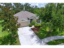 Well-maintained single-story home with neutral siding, mature landscaping, and an attached two-car garage at 4716 98Th E Ter, Parrish, FL 34219