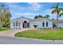 Charming single-story home with well-manicured lawn, stone-paved driveway, and lush tropical landscaping at 5139 50Th W Ave, Bradenton, FL 34210