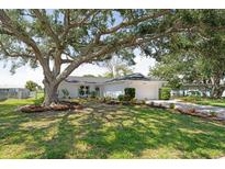 Charming single-story home with a well-manicured lawn and mature trees offering plenty of shade at 7308 17Th W Ave, Bradenton, FL 34209