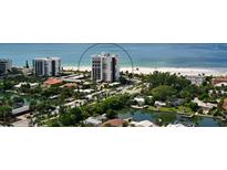 Scenic aerial view of beachfront condos and homes with lush greenery and waterfront access at 1 Benjamin Franklin Dr # 93, Sarasota, FL 34236