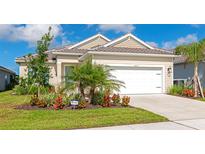 Charming single-Gathering home featuring well-maintained landscaping, healthy lawn, and a two car garage at 10177 Crystal Isle Cir, Sarasota, FL 34241