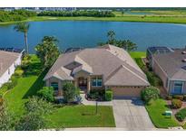 Stunning home featuring manicured lawn and lake view in a golf community, perfect for relaxed luxury living at 10571 Old Grove Cir, Bradenton, FL 34212