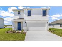 Two-story home with a two-car garage, blue front door, and well-manicured lawn at 12063 Lansing Gln, Parrish, FL 34219