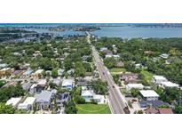 An aerial view shows the home's proximity to the beach and surrounding landscape at 1738 Siesta Dr, Sarasota, FL 34239