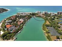 Stunning aerial view of waterfront homes along lush green waterways and Gulf beaches at 225 Sands Point Rd # 6201, Longboat Key, FL 34228