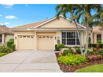 Charming one-story home features a well-maintained front yard with mature landscaping, a tile roof, and a two-car garage at 6155 Aviary Ct, Bradenton, FL 34203