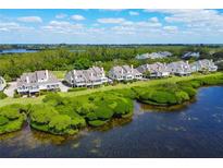 Waterfront condos with lush surroundings provide picturesque views and a serene coastal atmosphere at 65 Tidy Island Blvd, Bradenton, FL 34210