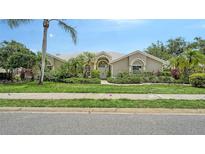Beautiful single-story home with well-manicured lawn and tropical landscaping at 8239 Cypress Hollow Dr, Sarasota, FL 34238