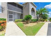 Charming condo exterior with a well-maintained lawn and screened in porch at 9580 High Gate Dr # 1822, Sarasota, FL 34238