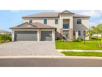 Charming two-story home boasts a three-car garage, beautiful landscaping, and inviting entryway at 15815 Tradewind Ter, Bradenton, FL 34211