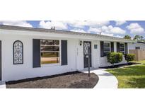 Charming home featuring a well-maintained exterior and landscaped front yard with walkway to the front door at 3167 Pinetree St, Port Charlotte, FL 33952