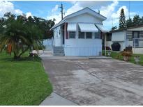 Charming single-story home featuring a well-maintained lawn, concrete driveway, and stylish awnings at 3333 26Th E Ave # 1023, Bradenton, FL 34208