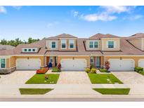 Beautiful townhomes boast manicured lawns, brick driveways, and colorful flowerbeds adding curb appeal at 3673 Fescue Ln, Sarasota, FL 34232