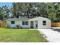 Charming single-story home with a freshly painted exterior, landscaping, and a welcoming teal front door at 4041 Linwood St, Sarasota, FL 34232